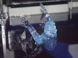 A Small Figurine Emerging From the Liquid SLA Resin after the SLA 3D Printing process