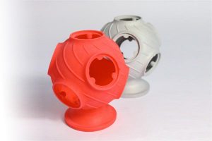 A red Castform-PS investment casting "Wax" and a subsequent aluminium casting